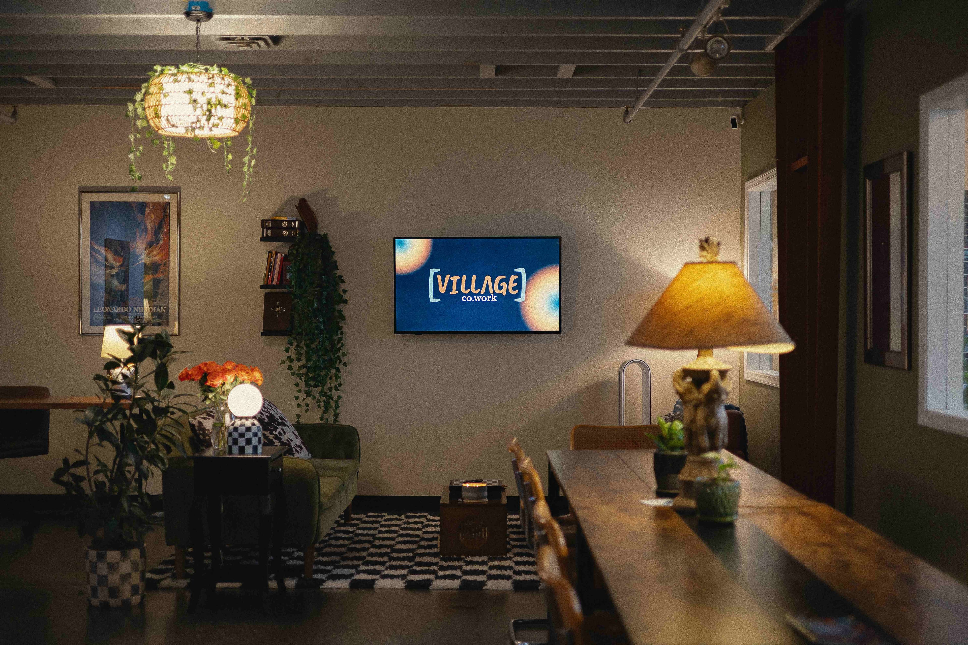 Villageco.work lounge area with TV and plants